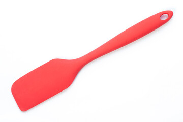 Red silicone spatula with copy space on the left.