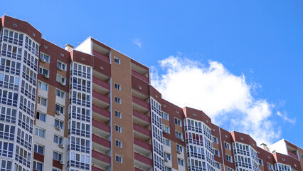 Large construction site on a background of blue sky. Brick, panel apartment building. Industrial theme for design
