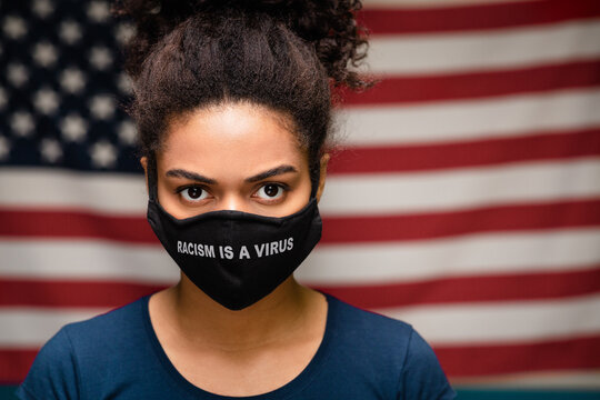 Black woman wearing protective mask text Racism is a Virus