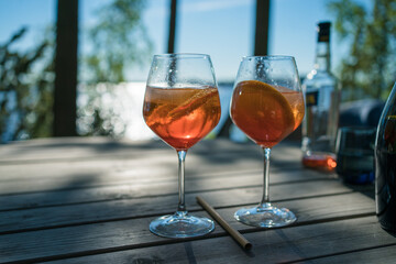 making a summer drink with sparkling wine in sunset outside