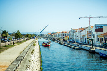 Fototapeta premium beautiful water canals between houses in the city of Aveiro in Portugal. Pure blue water