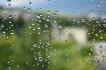 Raindrops on the glass. The sun is shining. Hope for a bright future
