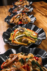 Variety of different noodle dishes asian style wok