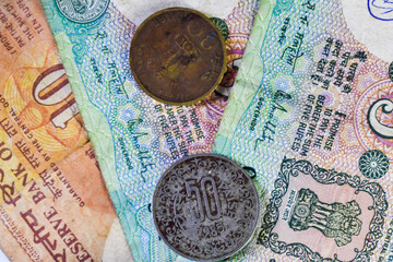 Background image of old Indian currency notes and coins.