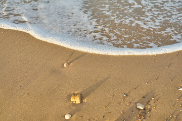Sea waves on the beach at sunset
