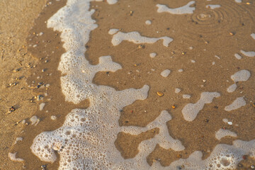 Sea waves on the beach at sunset