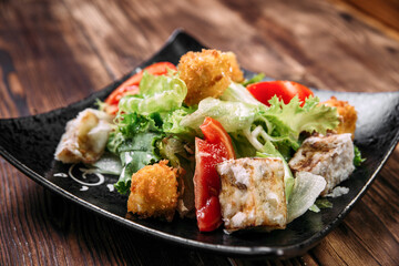 Caesar salad with fried tofu and deep-fried cheese