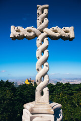 a large stone cross on top of a mountain 