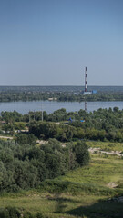 Outskirts of the city industrial zone on the background of a river or lake. Stock photo for design