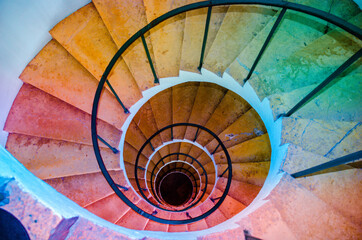 large twisted multi-colored stairs. stairs leading down. the concept of infinity