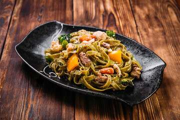 Spinach fettuccine pasta with beef and vegetables