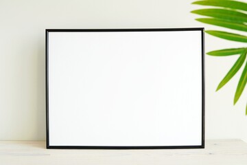 Black horizontal photo frame mockup and green palm leave, empty blank frame mock up, white...