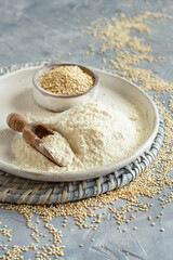 Raw white quinoa seeds and flour close up