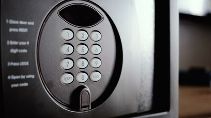 Small modern safe on shelf.Safe box in a hotel room