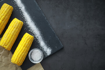 Freshly made fragrant ear of corn with salt. Farm snack of fresh corn. Healthy breakfast and healthy lifestyle concept.