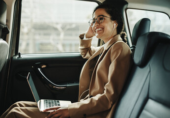 Smiling businesswoman travelling in a car - Powered by Adobe
