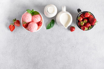 Obraz na płótnie Canvas Preparation strawberry ice cream. Ingredients for making ice cream. Bowl of ice cream, cream, strawberries on a concrete background, top view.