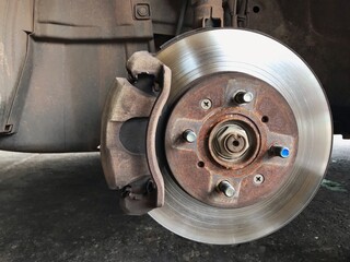 The mechanic is fixing the brakes of the car 