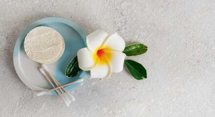clean wooden and cotton ear buds and sponges from loofah ecological recyclable in the bathroom on...