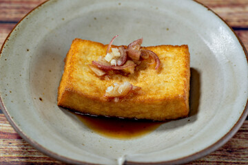 Thick fried tofu topped with ginger and myoga in Japan