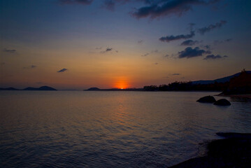 sunset on the beach on Koh Samui in Thailand, paradise, sunny beach, coconuts and palm trees, sunbathing and swimming in the sea, blue ocean and sky, travel to the resort, relaxation and enjoyment