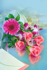 Bouquet of pink roses, orchids and gerberas on a white background