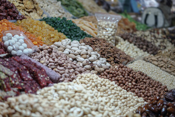 Rack on the market with dried fruits and nuts and Turkish sweets. Vegetarian food mix. Stock photo background for business