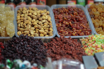 Rack on the market with dried fruits and nuts and Turkish sweets. Vegetarian food mix. Stock photo background for business