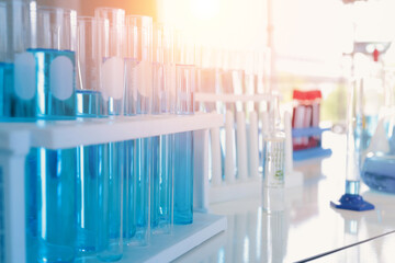 Asian Scientist working on blue test tube to analysis and develop vaccine of covid-19 virus in lab...