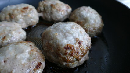 fried pork cutlet in a frying pan