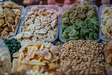Rack on the market with dried fruits and nuts and Turkish sweets. Vegetarian food mix. Stock photo...