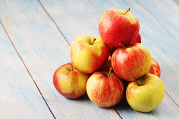 Several ripe red apples on the wooden table