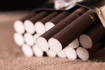 Slim brown cigarillos black background