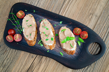 turkey liver pate sandwiches on wooden background