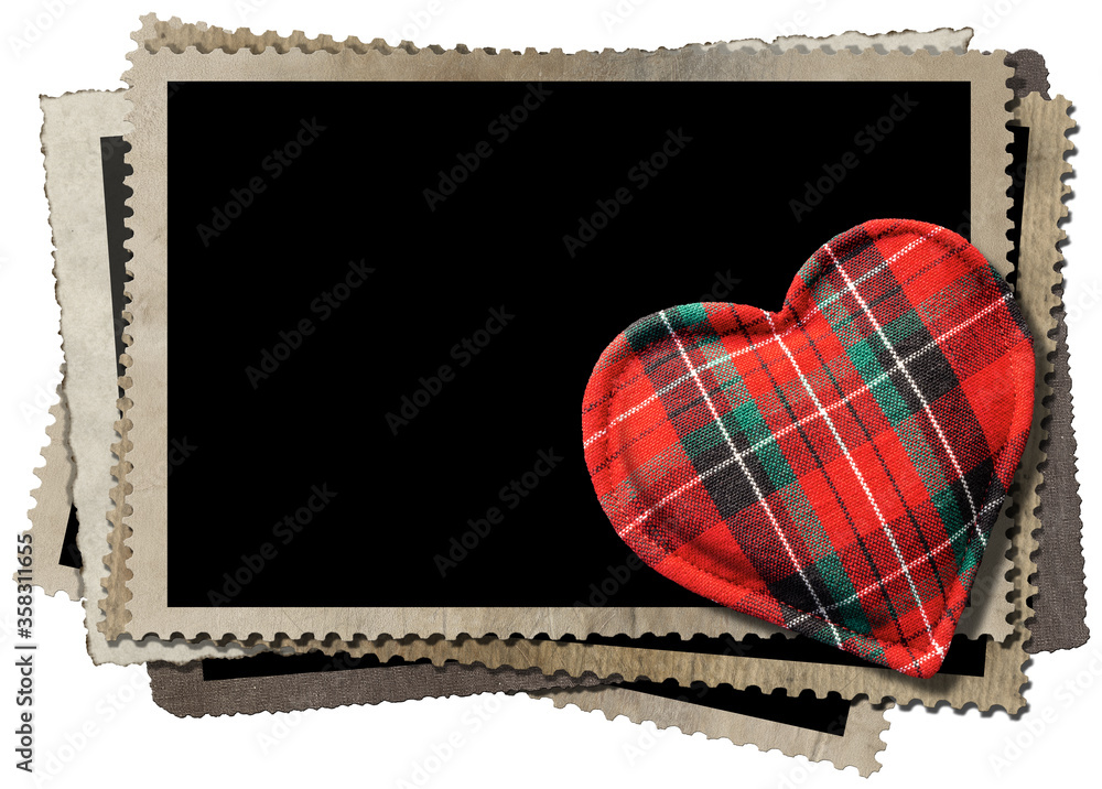 Poster closeup of a fabric heart shape on a stack of vintage empty photo frames. isolated on white backgrou