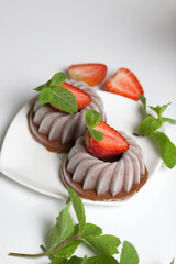 Chocolate fudge garnished with half a strawberry with petals. Garnished with sprigs of mint and...