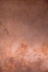 Copper surface. Scratched copper plate in daylight in Ukraine. Copy space. Minimalism. Vertical image.