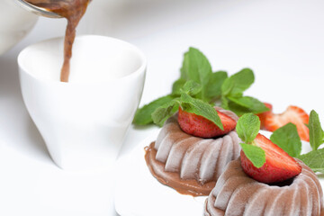 Chocolate fudge garnished with half a strawberry with petals. Garnished with sprigs of mint and...