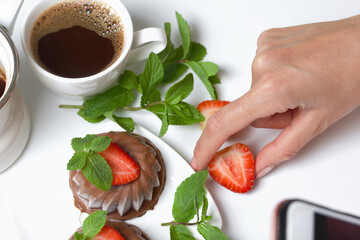 Chocolate fudge garnished with half a strawberry with petals. Garnished with sprigs of mint and...