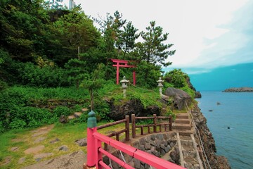 Fototapeta na wymiar Benten rock and coast line in Itoigawa city, Niigata, Japan in summer, scenic japanese landscape with oceanview