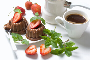 Chocolate fudge garnished with half a strawberry with petals. Garnished with sprigs of mint and...