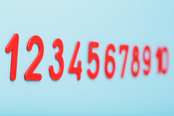 Red numbers on a blue background in a row from one to ten.