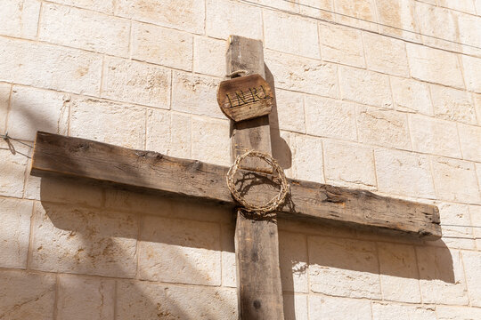 A large wooden cross with a crown of thorns and the inscription - INRI - in the old city of Jerusalem, in Israel