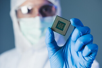 Scientist holding a chipset  - obrazy, fototapety, plakaty