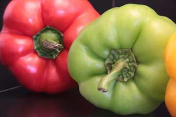 colorful organic peppers on a black background