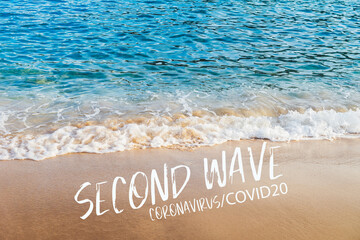 Second wave, Coronavirus, COVID19 text in white on natural background. Concept of fear of second wave coronavirus pandemic outbreak. Real blue sea and golden sand on the beach in Europe.