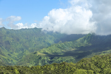 Emerald mountains with blue sky and clouds in Hawaii.