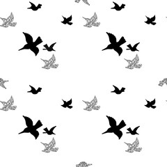 Flying birds silhouette black and white seamless pattern in a chaotic mess