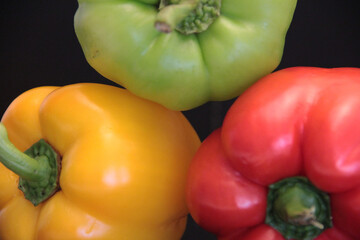 colorful organic peppers on a black background