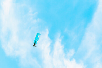 Antiseptic alcohol bottle floating on blue sky background, Campaign to prevent the spread of the Corona virus (Covid-19). New normal concept.